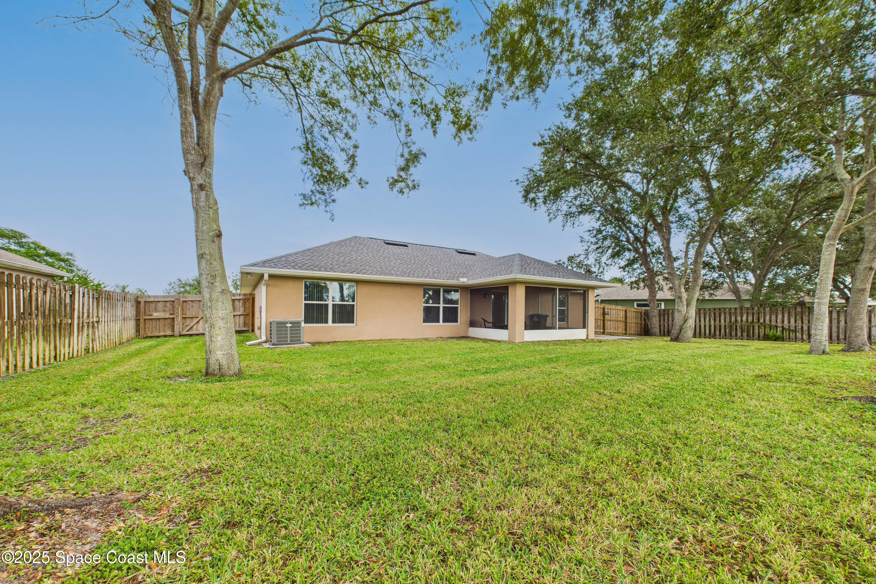 1936 Gloria Circle Palm Bay, FL 32905 - Photo 40 of 50 a front view of a house with a garden