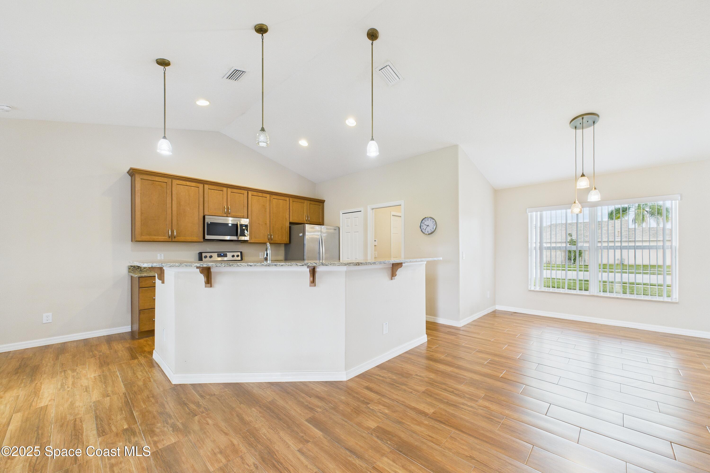 1936 Gloria Circle Palm Bay, FL 32905 - Photo 9 of 50 a view of kitchen with stainless steel appliances granite countertop a sink a window and a refrigerator