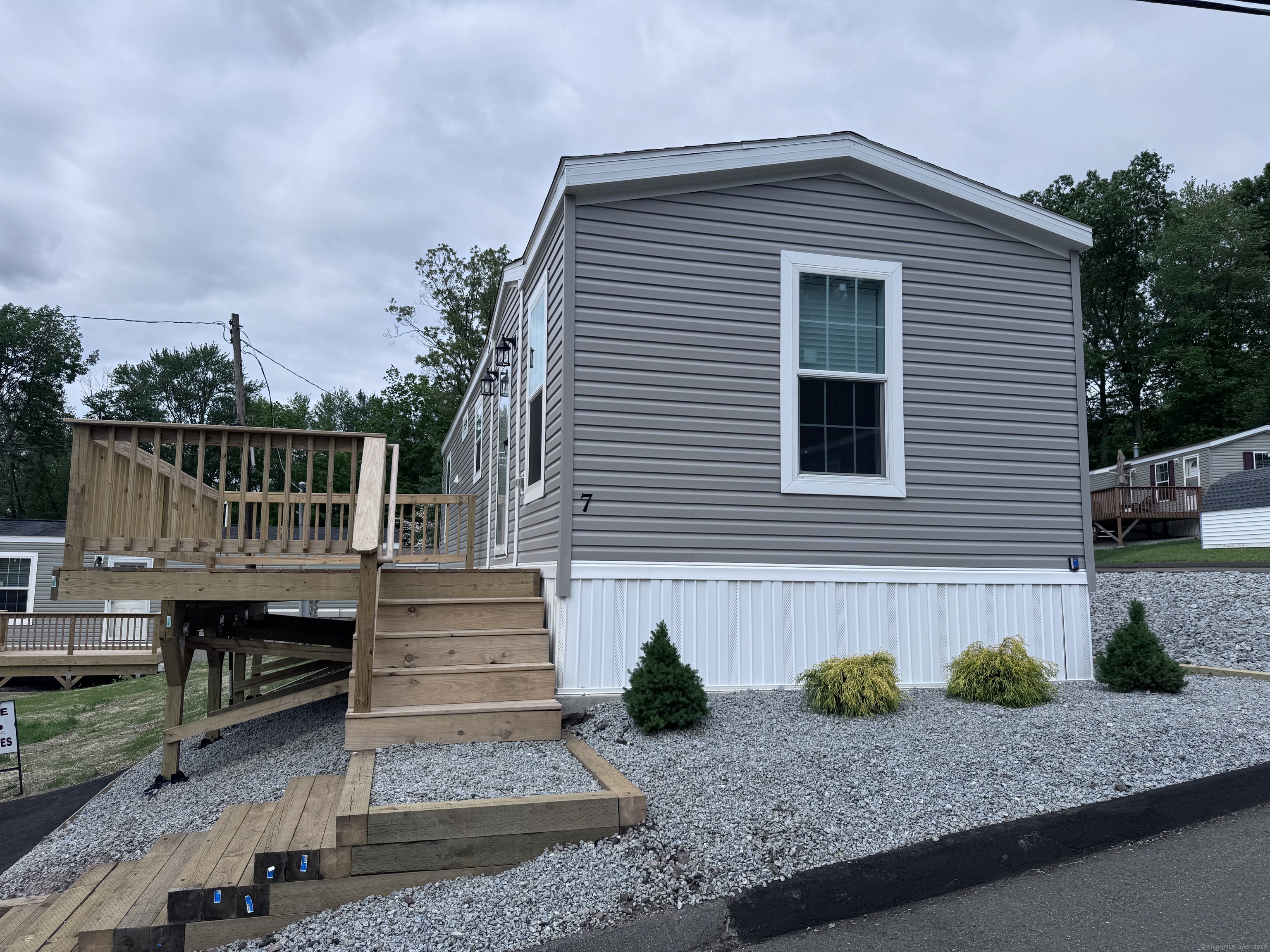 a front view of a house with garage and stairs