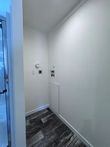 a room with a stove and wooden floor