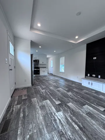 a view of a room window and wooden floor
