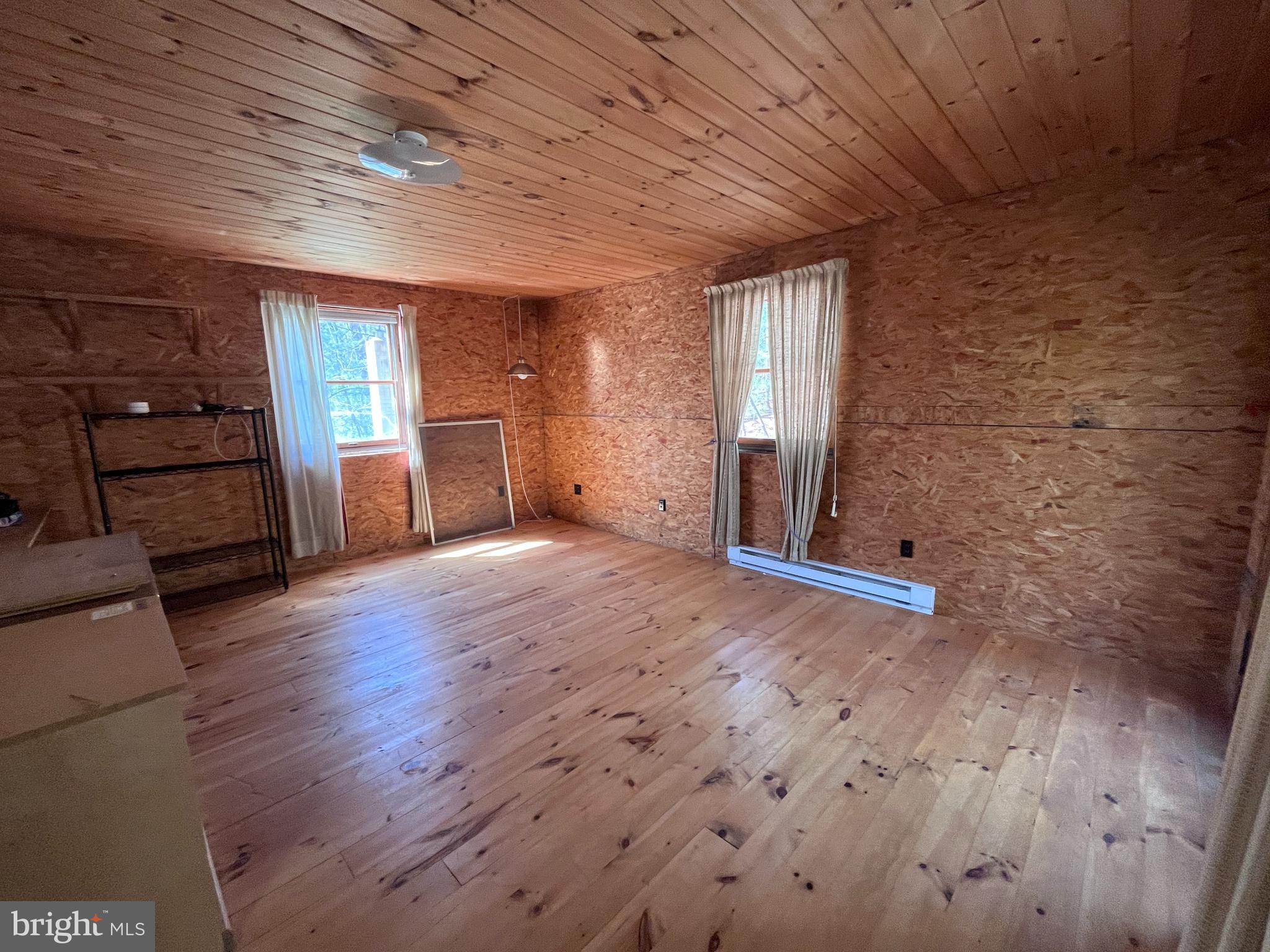 1343 Houser Road Fayetteville, PA 17222 - Photo 38 of 58 an empty room with wooden floor and windows