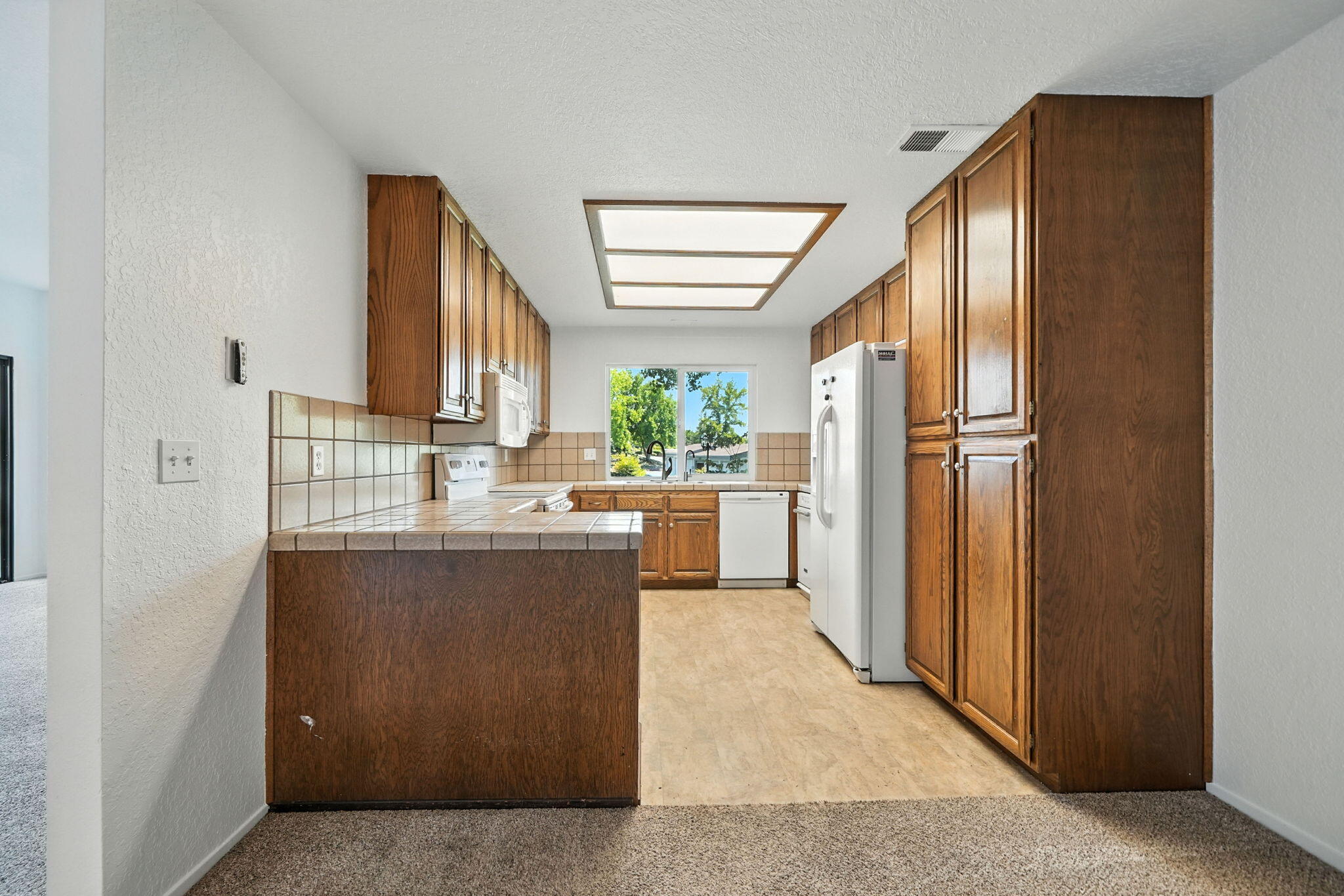 488 Ridgecrest Trail, Unit 133 Redding, CA 96003 - Photo 11 of 30 a kitchen with stainless steel appliances granite countertop a refrigerator and a sink