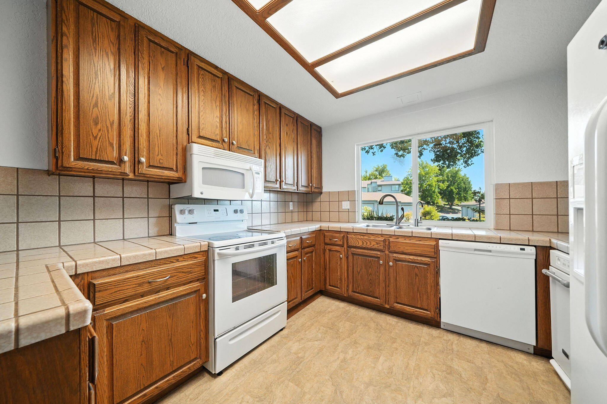 488 Ridgecrest Trail, Unit 133 Redding, CA 96003 - Photo 12 of 30 a kitchen with granite countertop cabinets stainless steel appliances and a large window