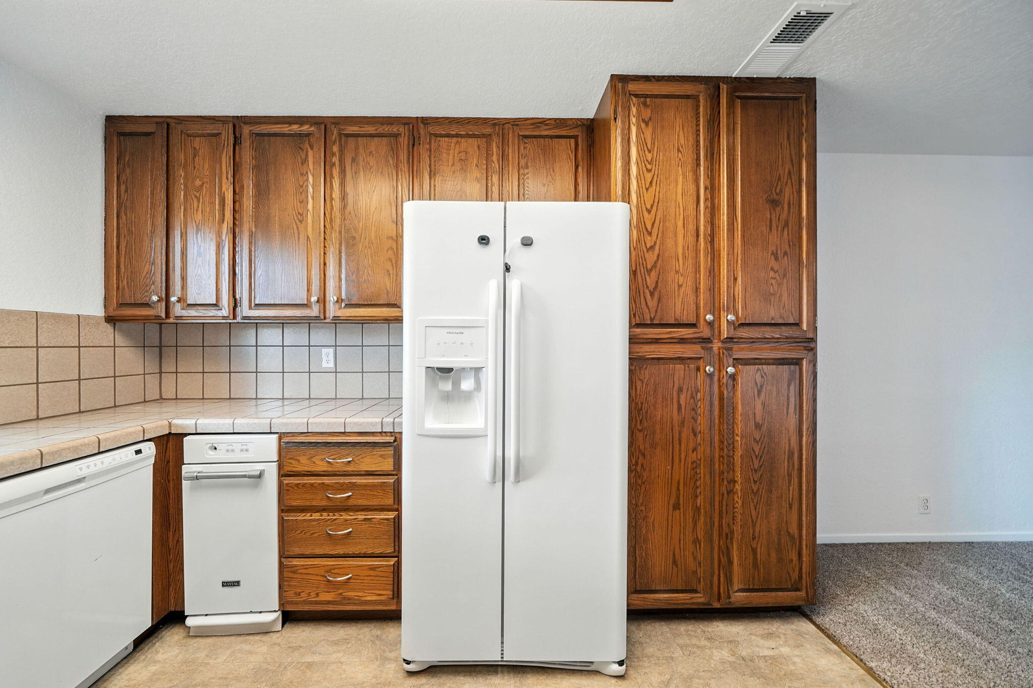488 Ridgecrest Trail, Unit 133 Redding, CA 96003 - Photo 14 of 30 a kitchen with a refrigerator and cabinets