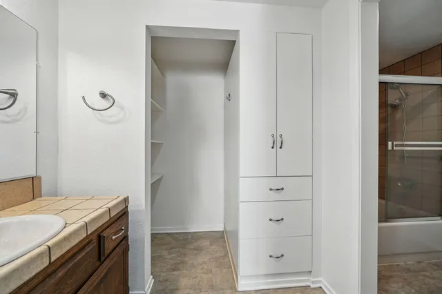 a bathroom with a sink a toilet a mirror and shower curtain