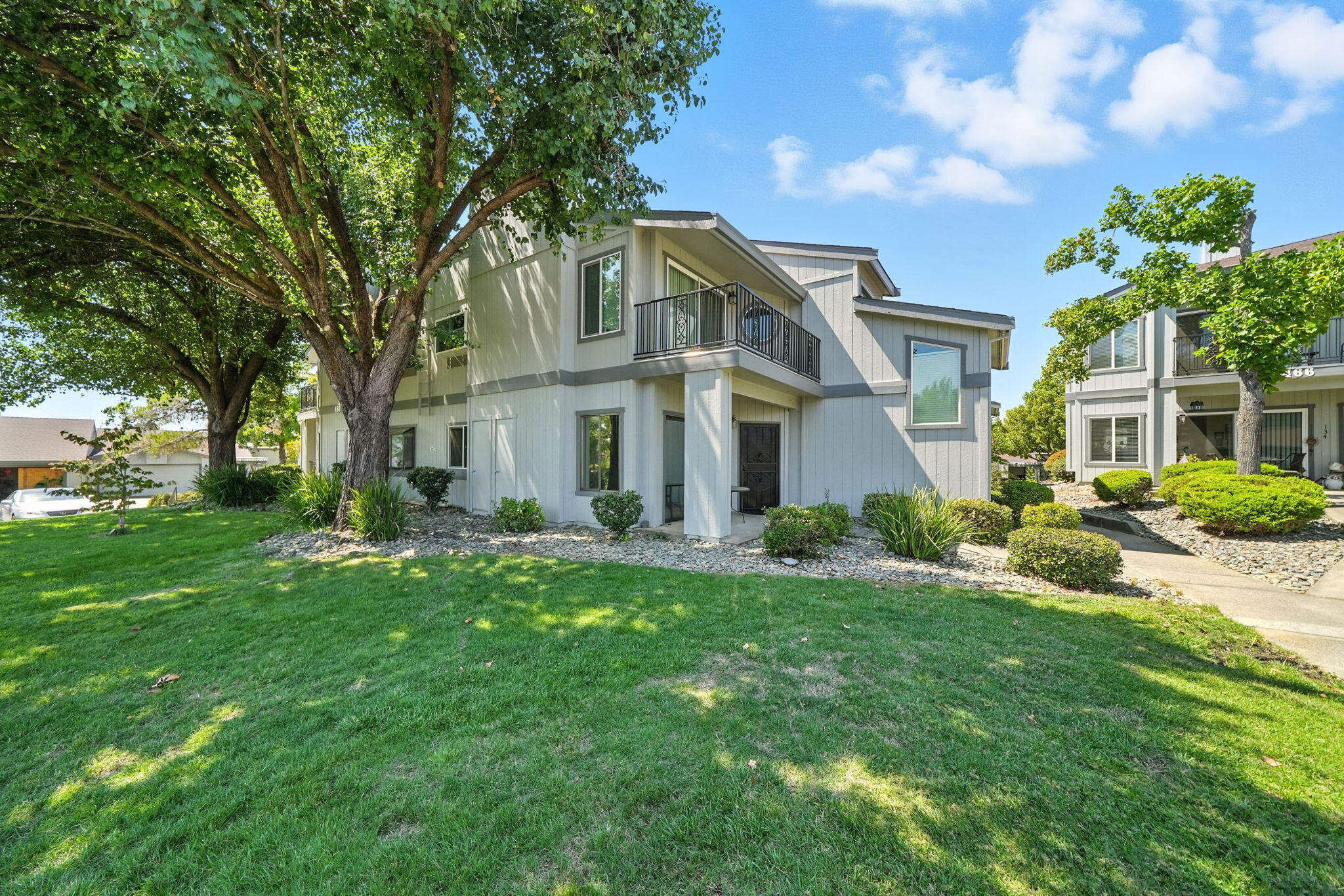 488 Ridgecrest Trail, Unit 133 Redding, CA 96003 - Photo 26 of 30 a front view of a house with a yard