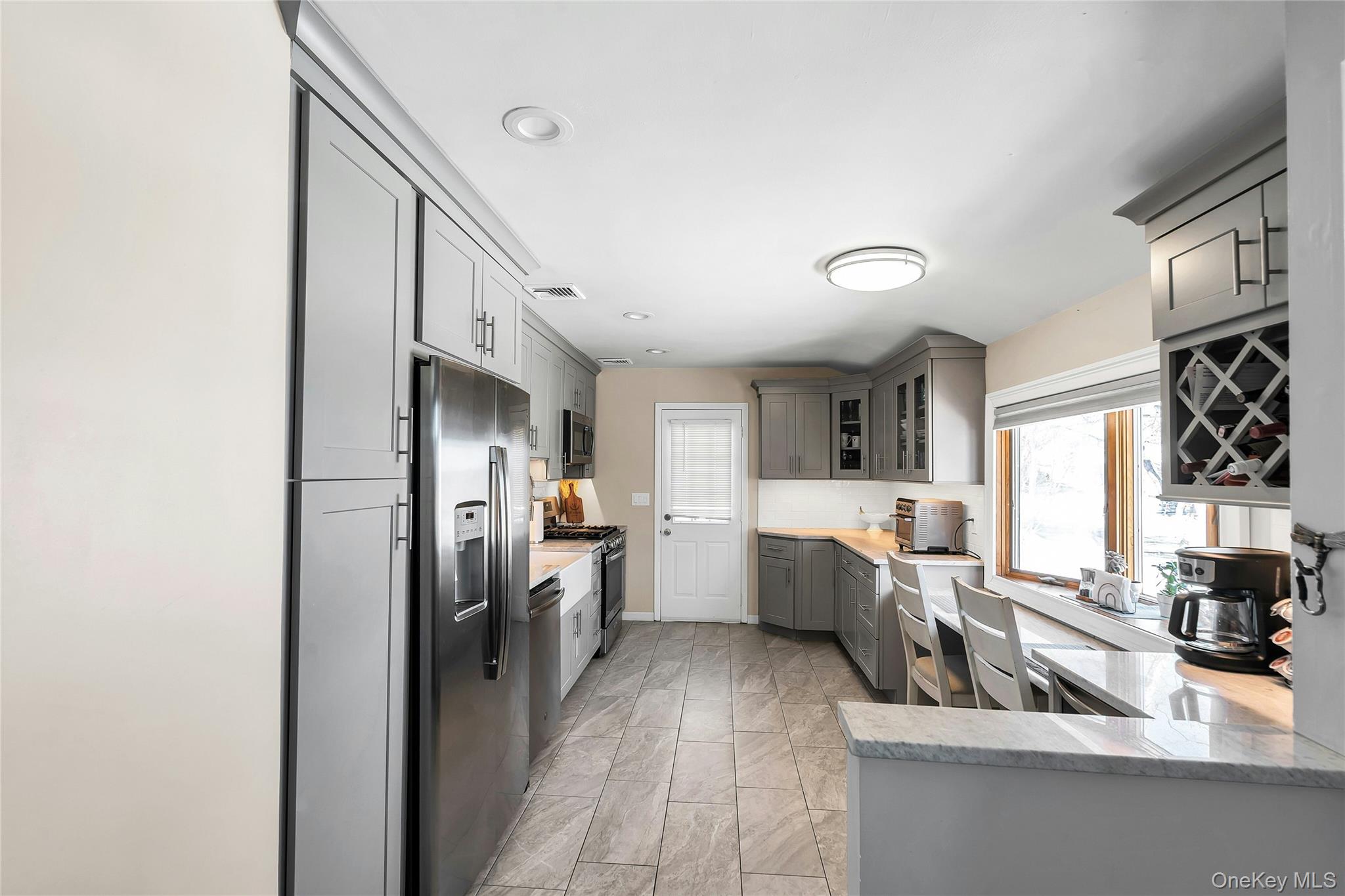 53 Calvert Avenue Commack, NY 11725 - Photo 11 of 25 a kitchen with cabinets and window