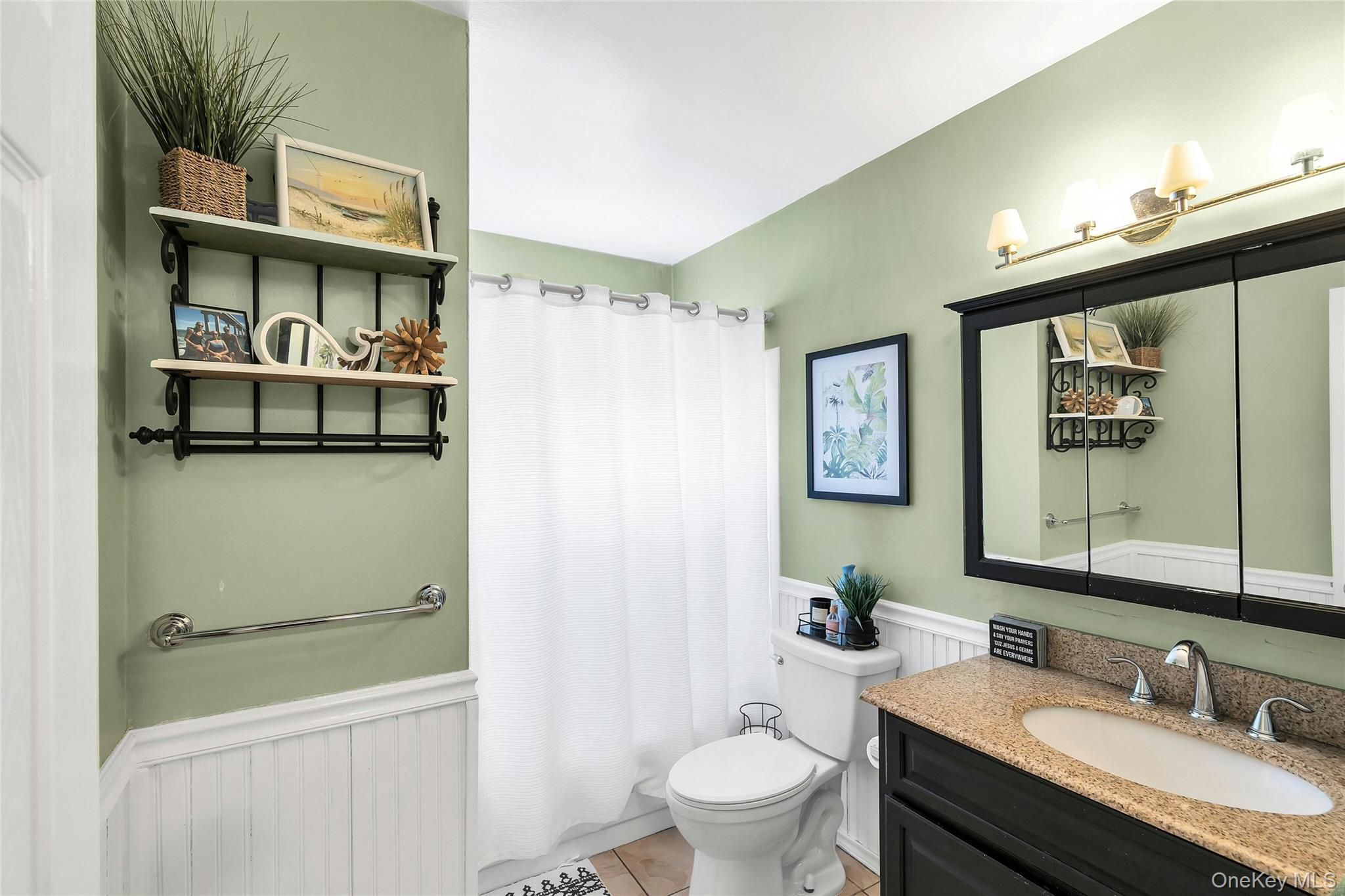 53 Calvert Avenue Commack, NY 11725 - Photo 15 of 25 a bathroom with a granite countertop sink mirror vanity and toilet