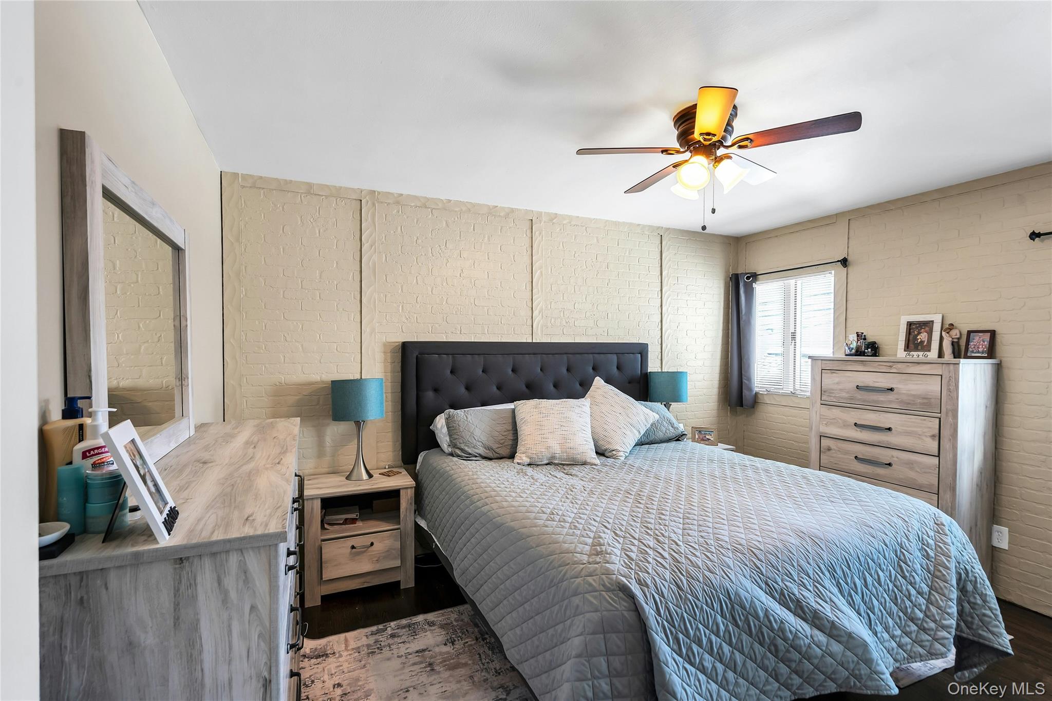 53 Calvert Avenue Commack, NY 11725 - Photo 16 of 25 a bedroom with a bed and a chandelier