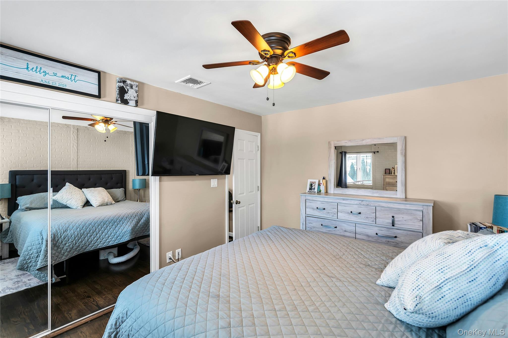 53 Calvert Avenue Commack, NY 11725 - Photo 17 of 25 a bedroom with a bed and a flat tv screen on dresser