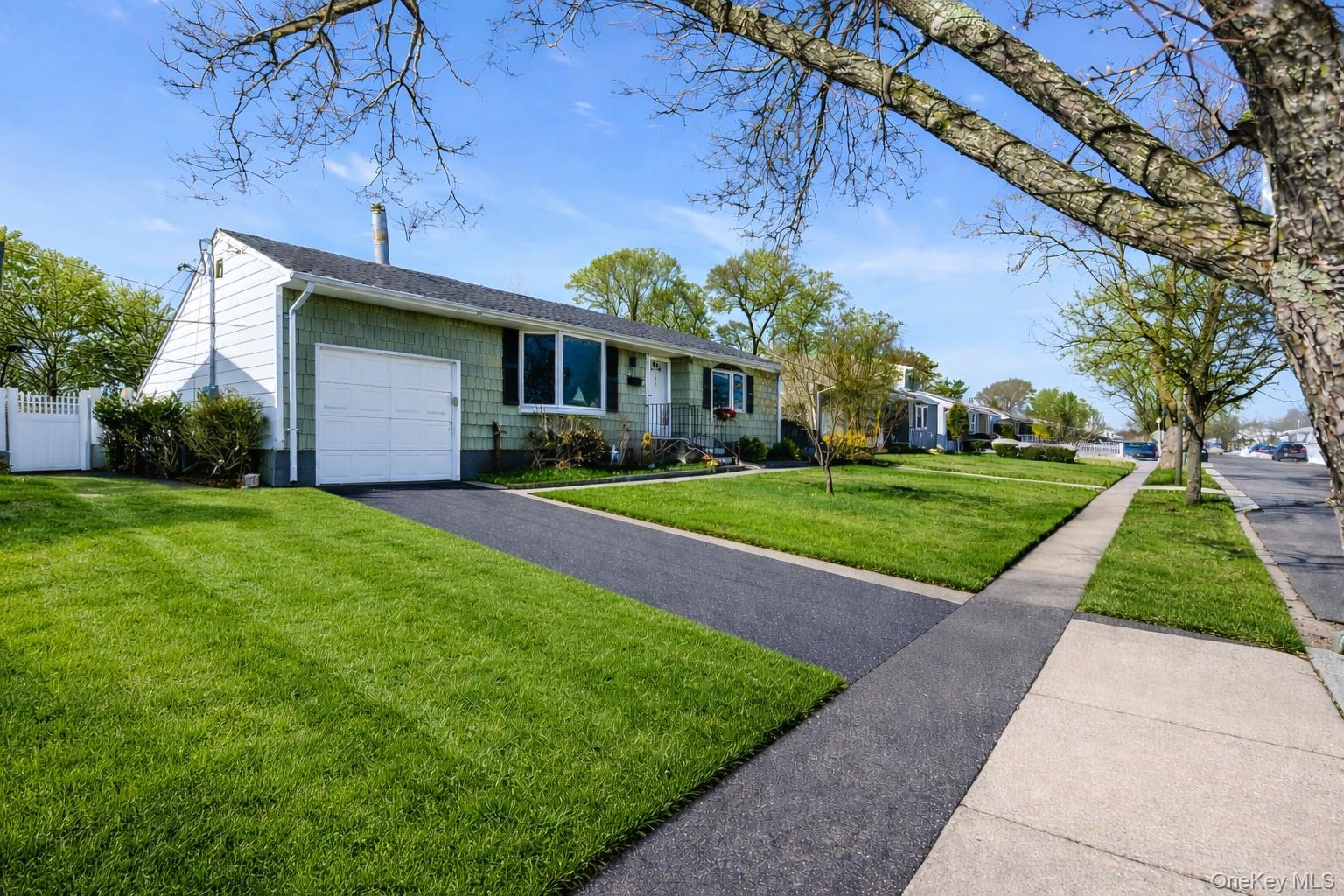 53 Calvert Avenue Commack, NY 11725 - Photo 2 of 25 a front view of a house with a yard