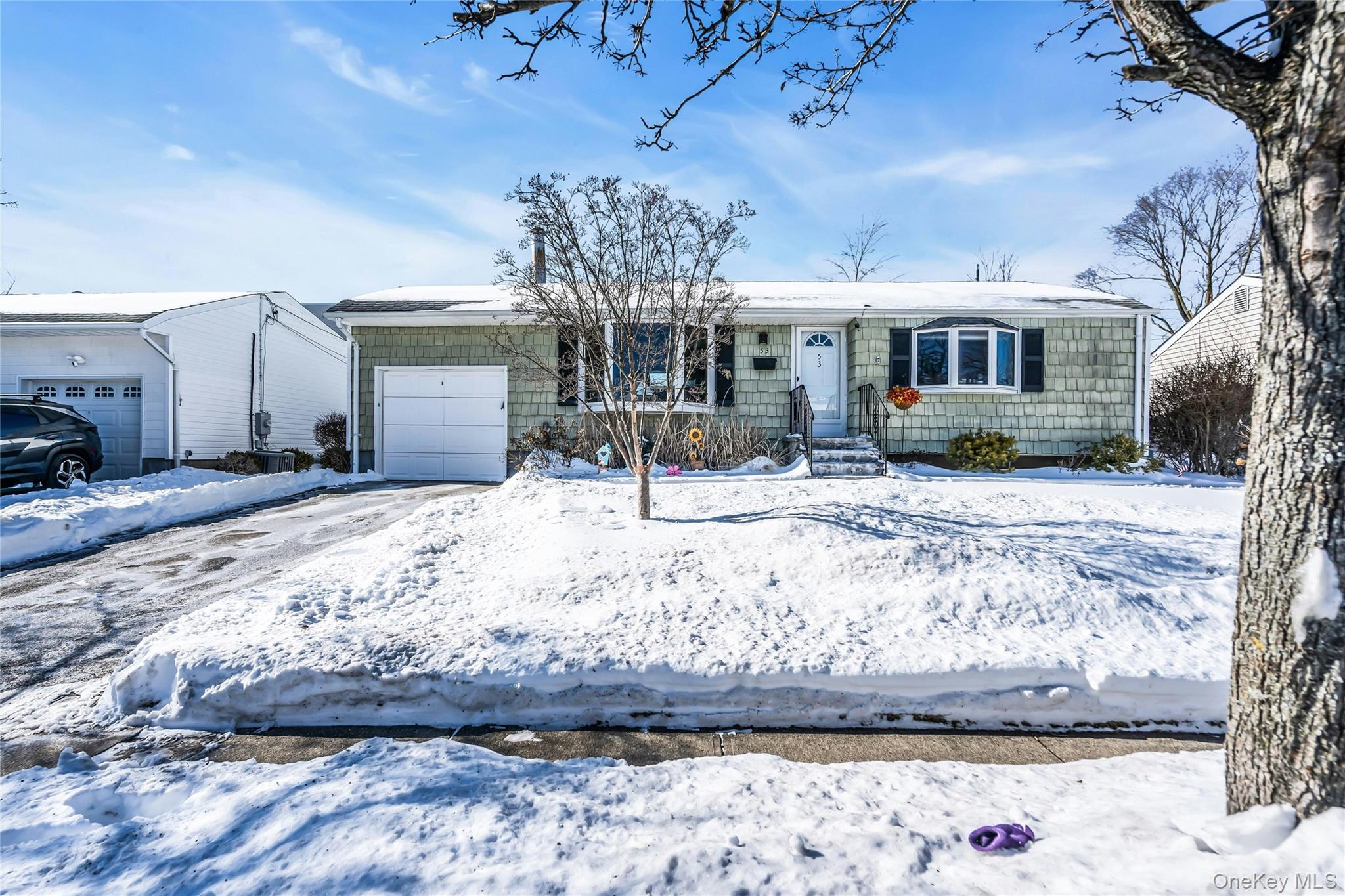 53 Calvert Avenue Commack, NY 11725 - Photo 4 of 25 a front view of a house with snow