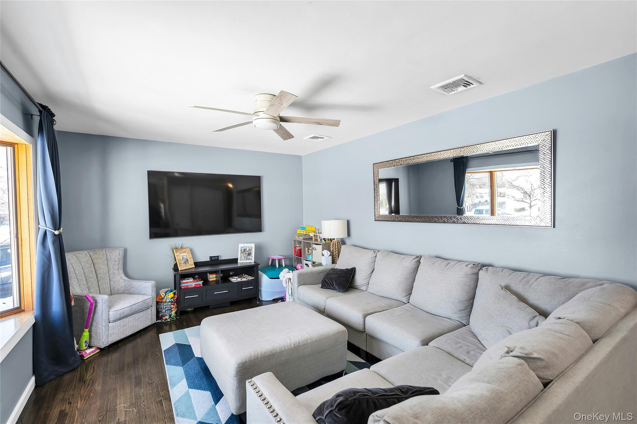 53 Calvert Avenue Commack, NY 11725 - Photo 6 of 25 a living room with furniture and a flat screen tv