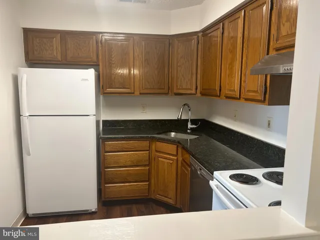 a kitchen with a refrigerator and cabinets