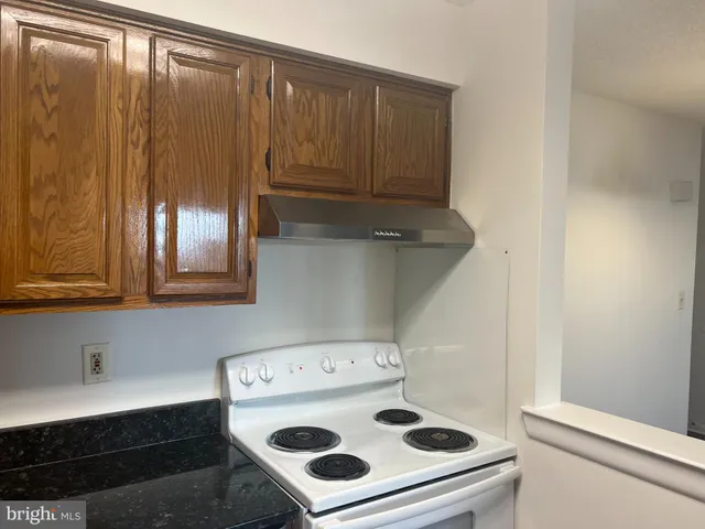 a kitchen with a stove and a cabinet