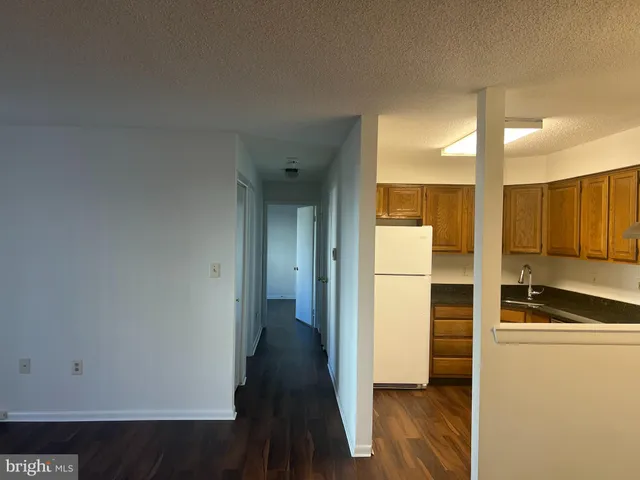 a view of a kitchen with a refrigerator and microwave