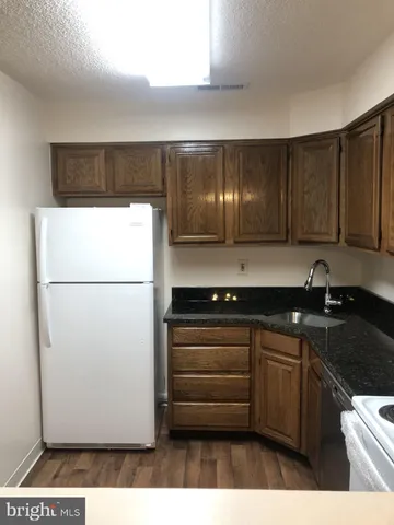 a kitchen with a refrigerator and a sink