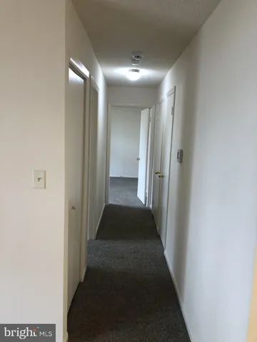 a room with wooden floor and white walls