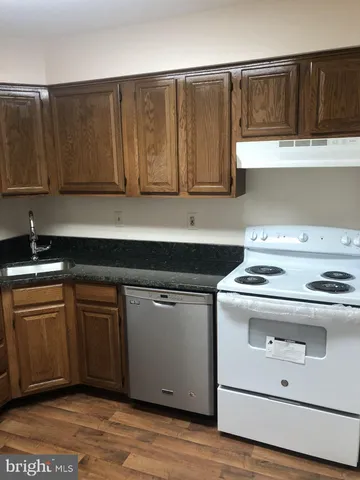 a kitchen with a refrigerator and a sink