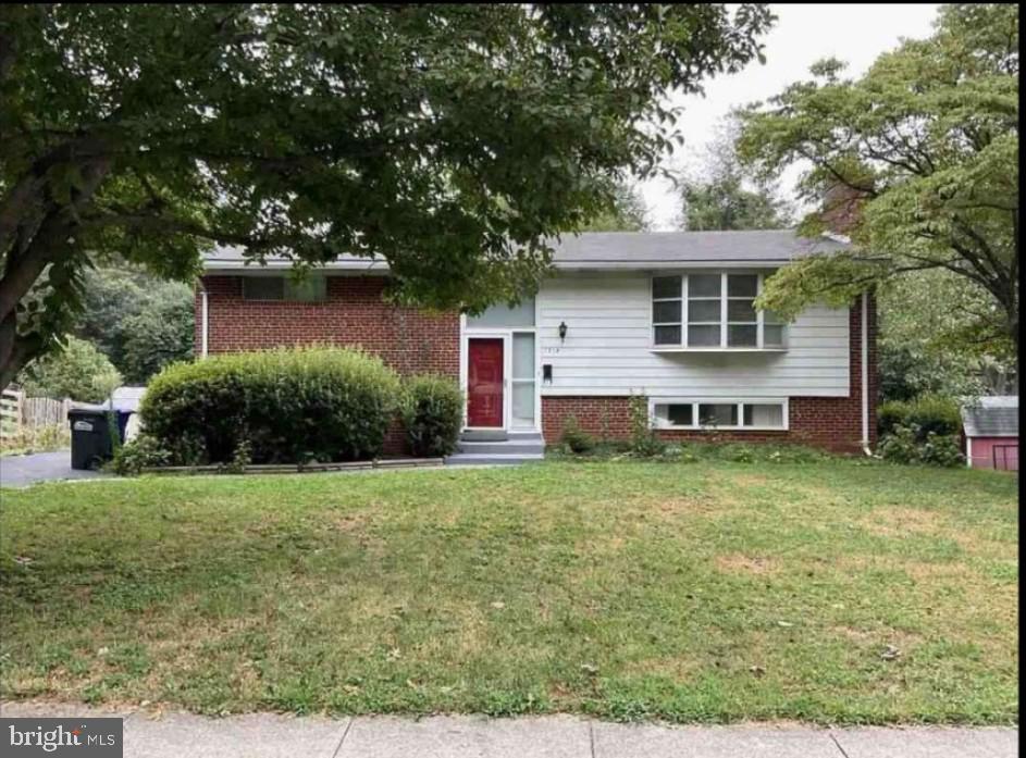 a view of a house with a yard and a garden