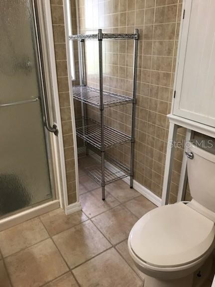 25624 Madison Street Astatula, FL 34705 - Photo 15 of 20 a bathroom with a toilet and a shower