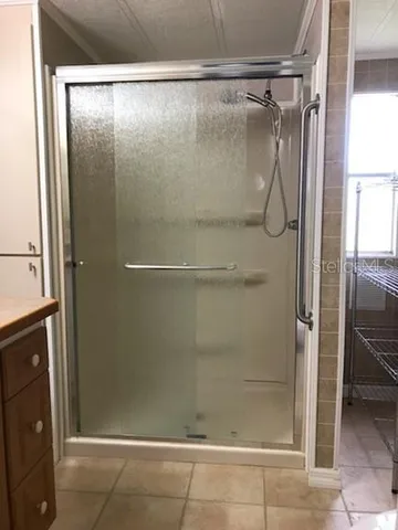 a bathroom with a glass shower door