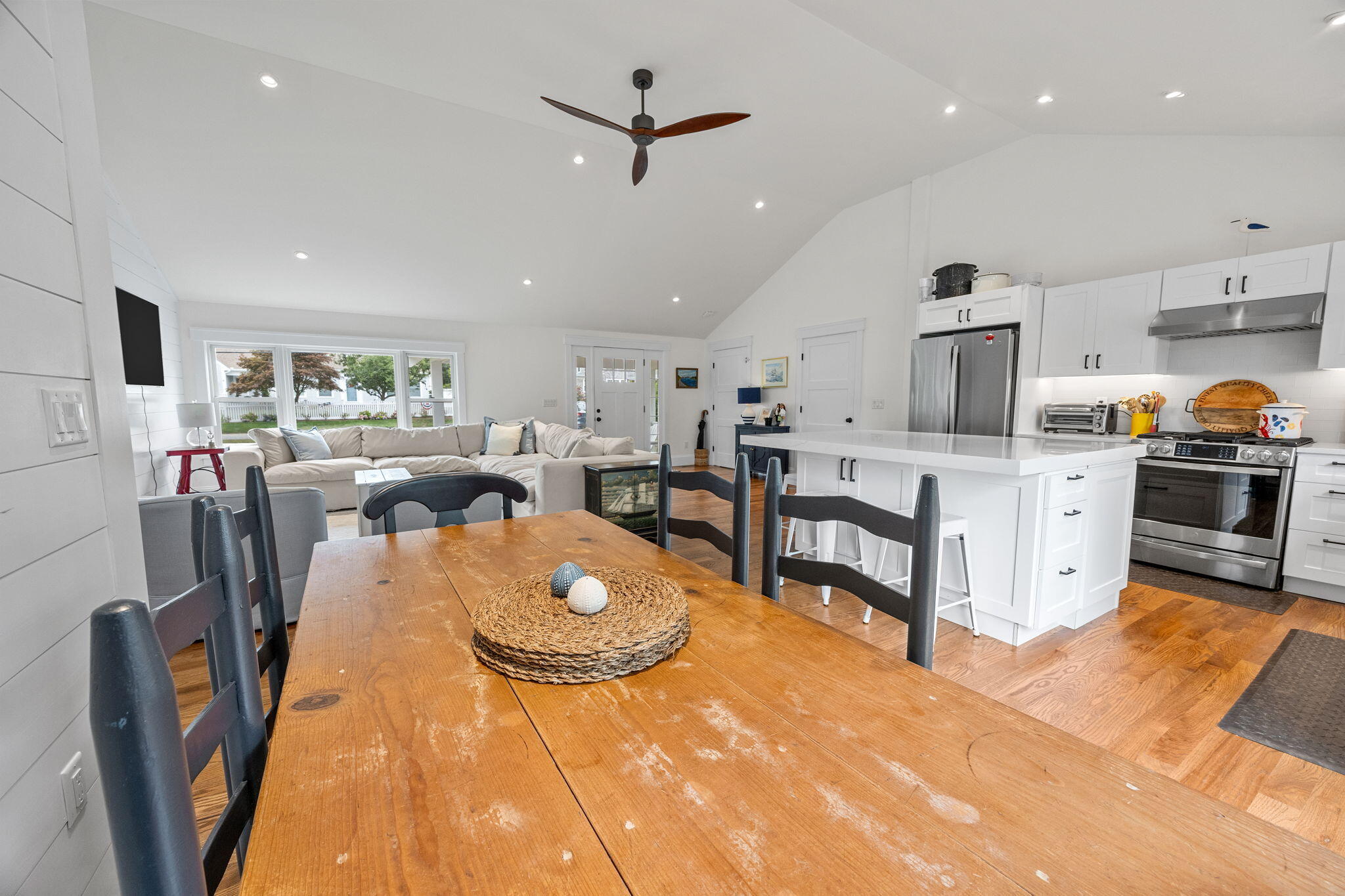 93 Orleans Road Chatham, MA 02633 - Photo 14 of 48 a living room with stainless steel appliances furniture a rug kitchen view and a chandelier
