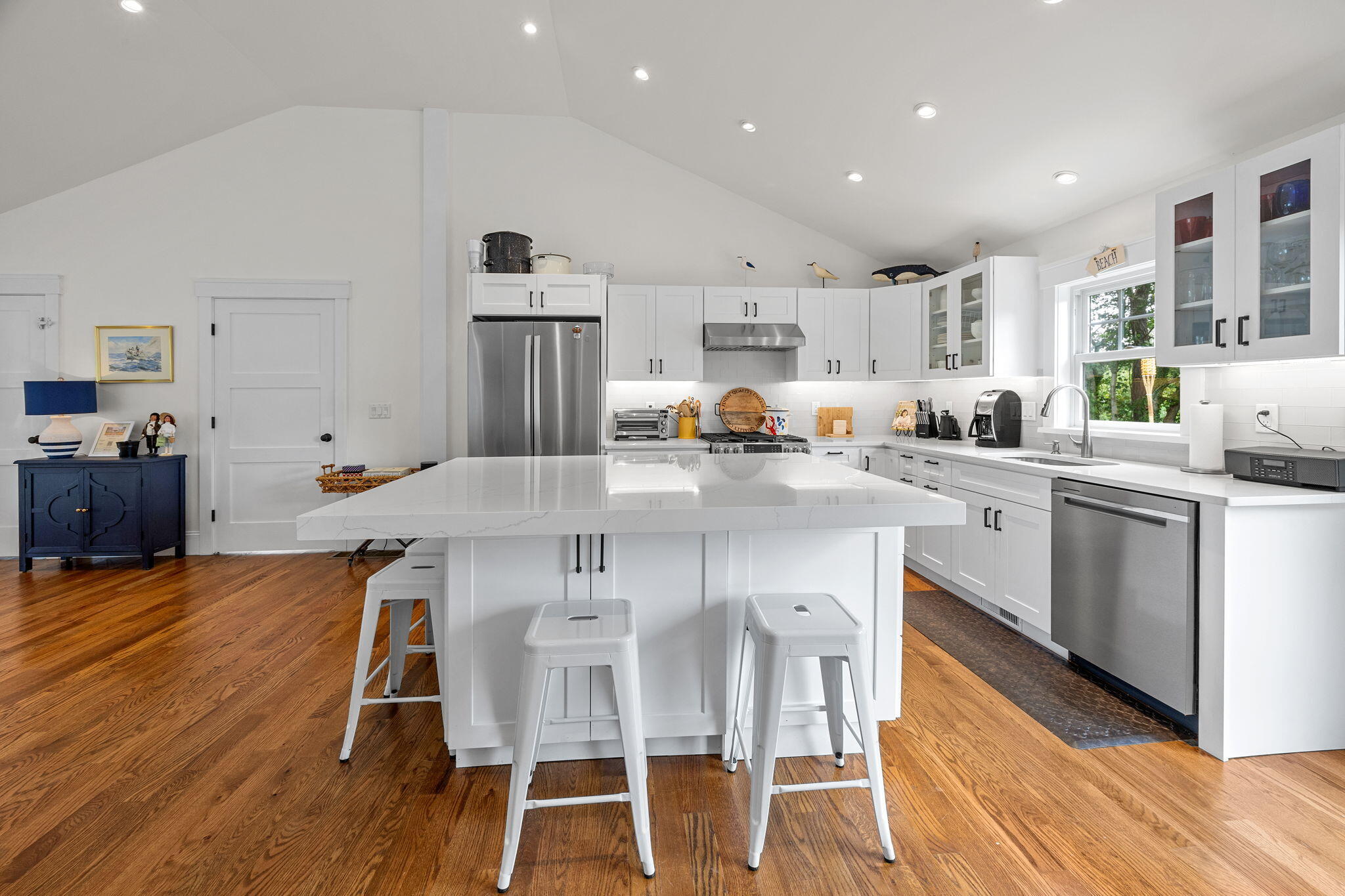 93 Orleans Road Chatham, MA 02633 - Photo 16 of 48 a kitchen with stainless steel appliances a table chairs refrigerator and cabinets