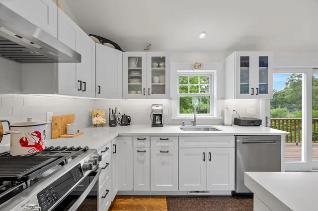a kitchen with a sink stove and cabinets