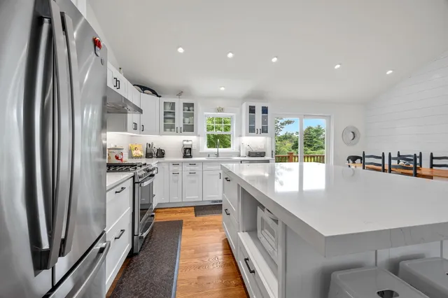a kitchen with stainless steel appliances granite countertop a refrigerator and a sink