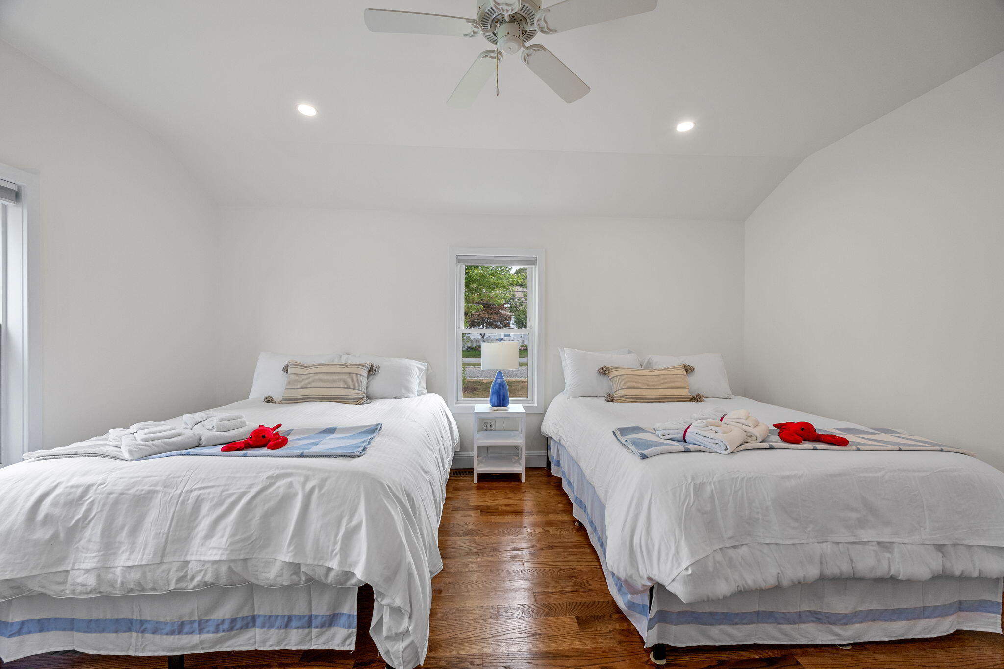 93 Orleans Road Chatham, MA 02633 - Photo 23 of 48 a bedroom with two beds and a chandelier