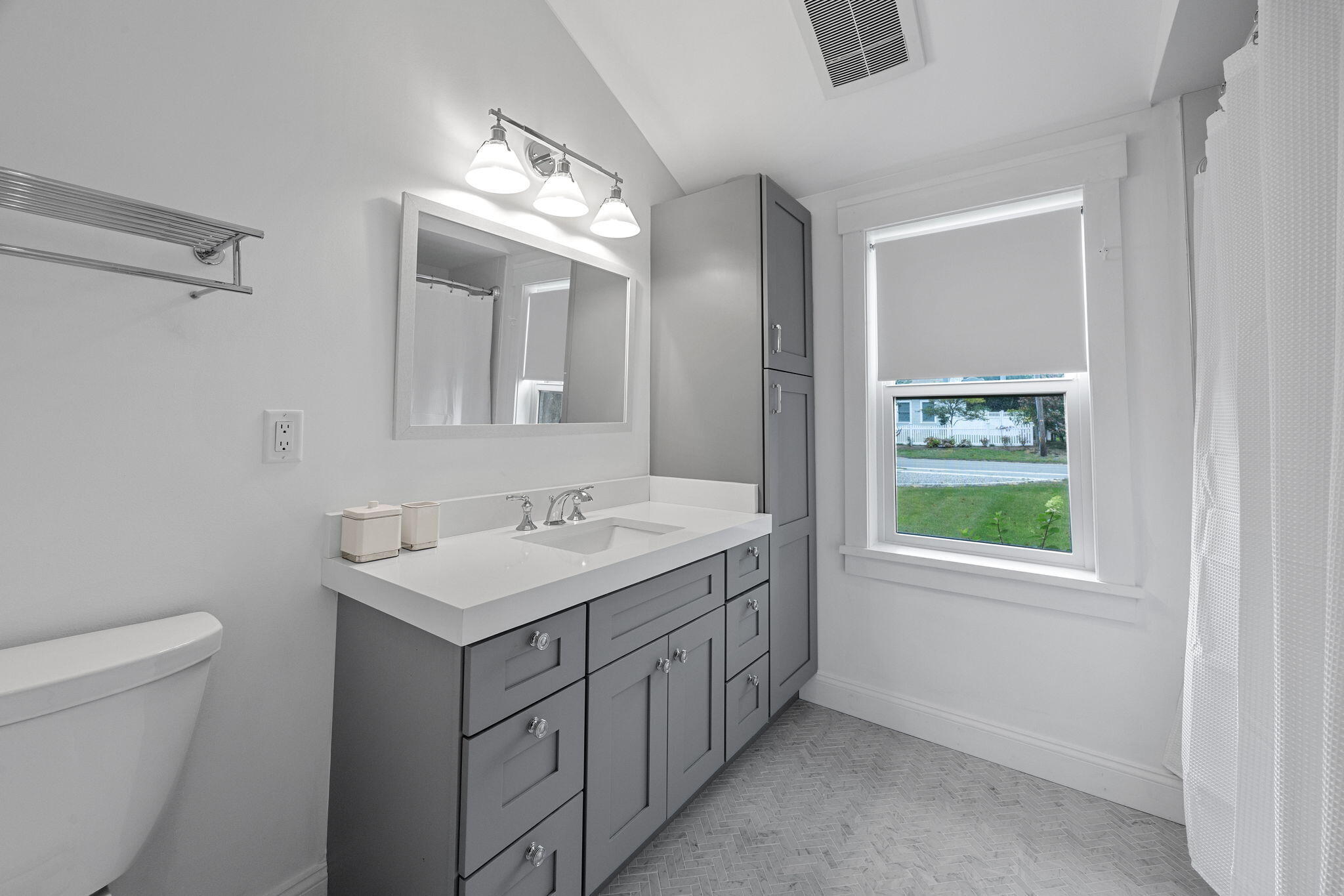 93 Orleans Road Chatham, MA 02633 - Photo 32 of 48 a bathroom with a toilet a sink a mirror and a window