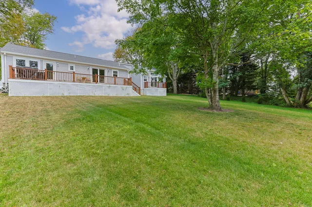 a view of a house with a backyard