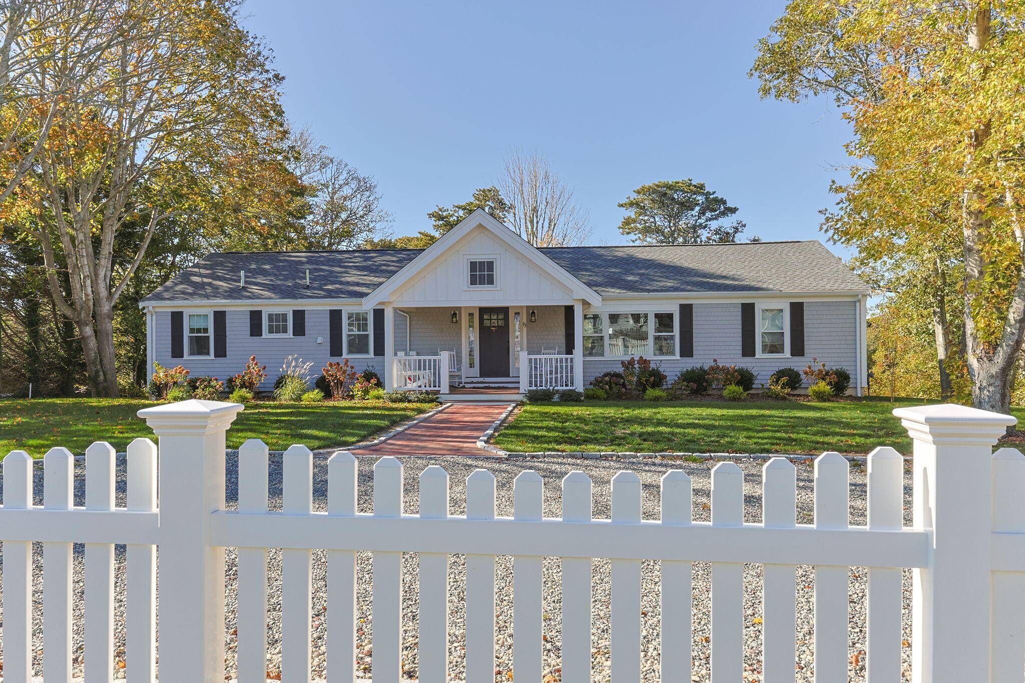 93 Orleans Road Chatham, MA 02633 - Photo 42 of 48 a front view of a house with a yard table and chairs
