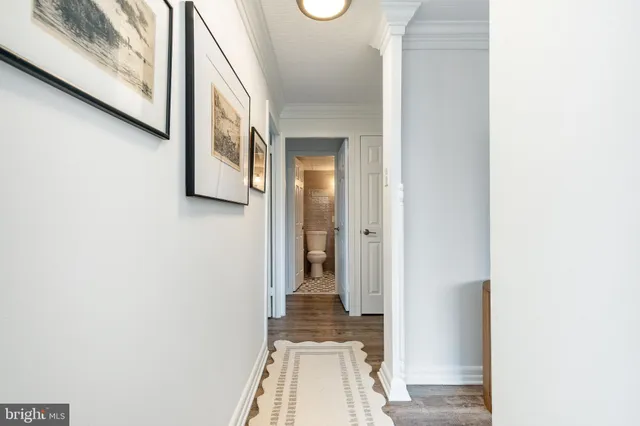 a view of a hallway with wooden floor