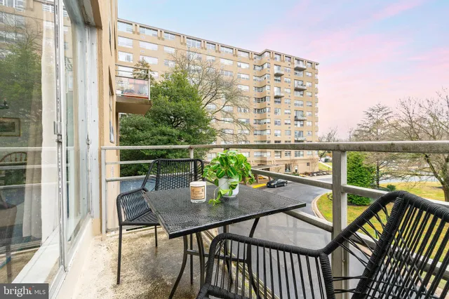 a view of a balcony with chairs and wooden floor