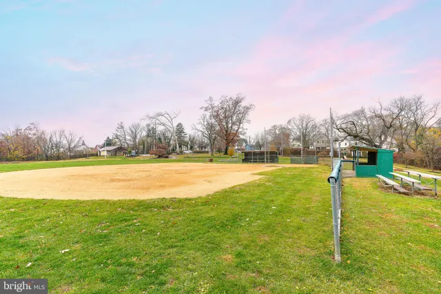 a view of yard with swimming pool and green space