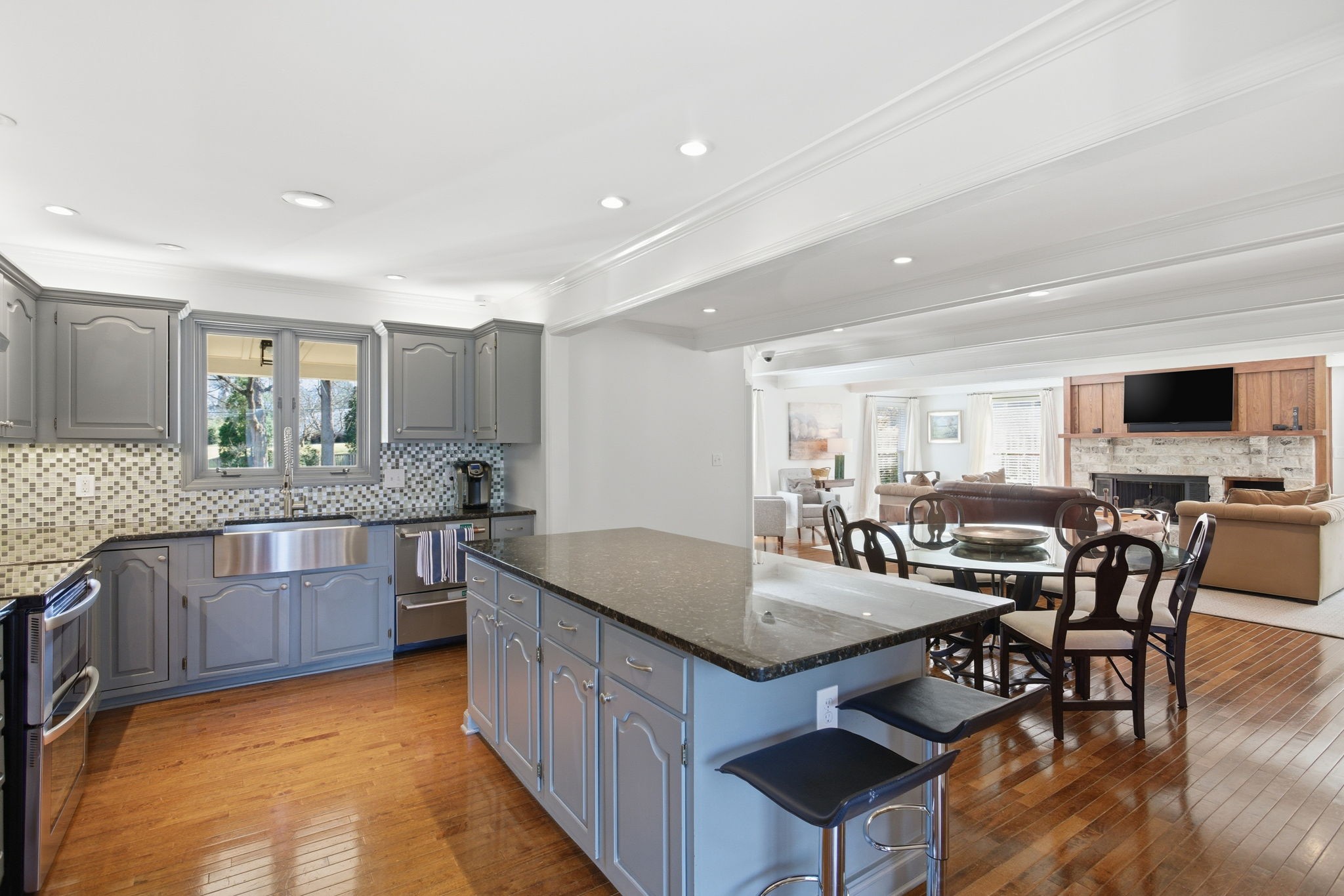 714 Farrell Road Nashville, TN 37220 - Photo 12 of 66 a kitchen with stainless steel appliances granite countertop a table chairs sink and cabinets