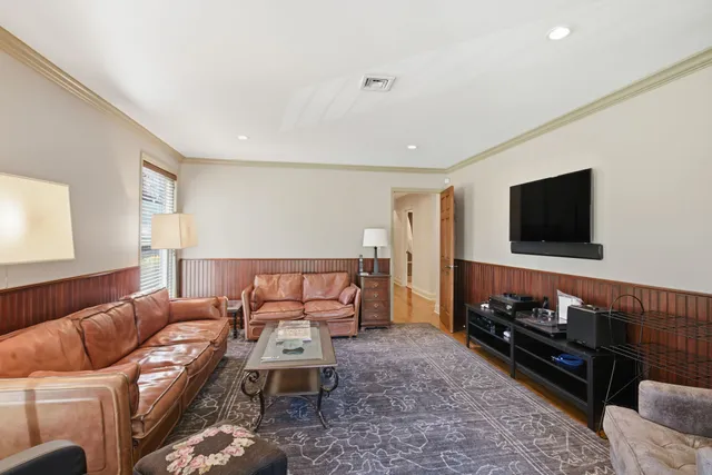 a room with painting on the wall and a glass door