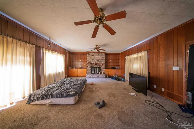a bedroom with a bed mirror and window