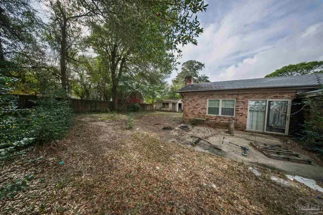 a view of a house with yard and a garden