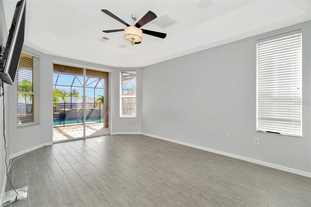 8918 Linebrook Drive Trinity, FL 34655 - Photo 14 of 50 an empty room with wooden floor and windows