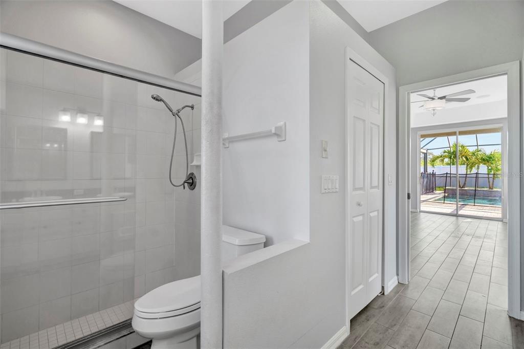 8918 Linebrook Drive Trinity, FL 34655 - Photo 20 of 50 a bathroom with a granite countertop shower a toilet and a shower