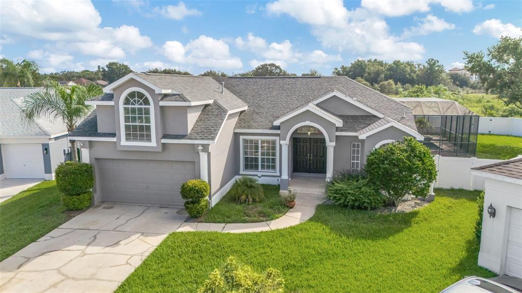 8918 Linebrook Drive Trinity, FL 34655 - Photo 2 of 50 a front view of a house with garden