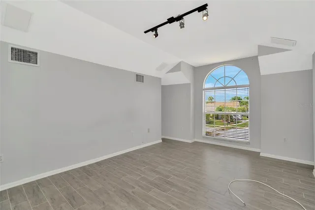 wooden floor in an empty room with a window