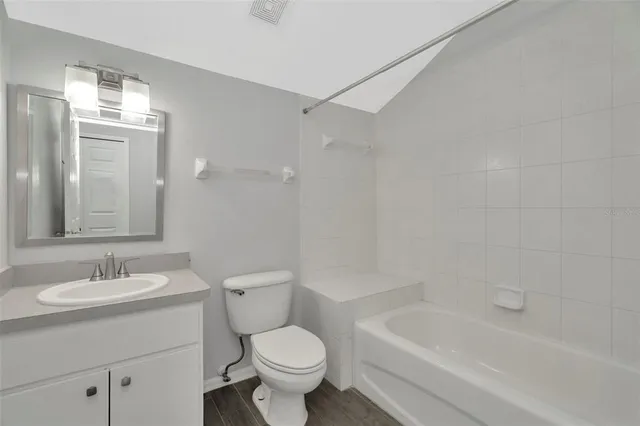 a view of an empty room with window and chandelier