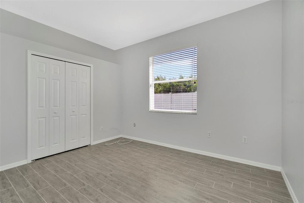 8918 Linebrook Drive Trinity, FL 34655 - Photo 37 of 50 an empty room with wooden floor and windows