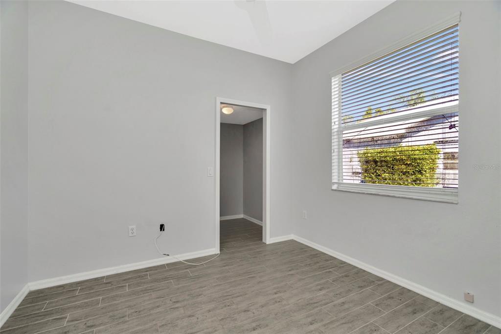 8918 Linebrook Drive Trinity, FL 34655 - Photo 38 of 50 an empty room with wooden floor and windows