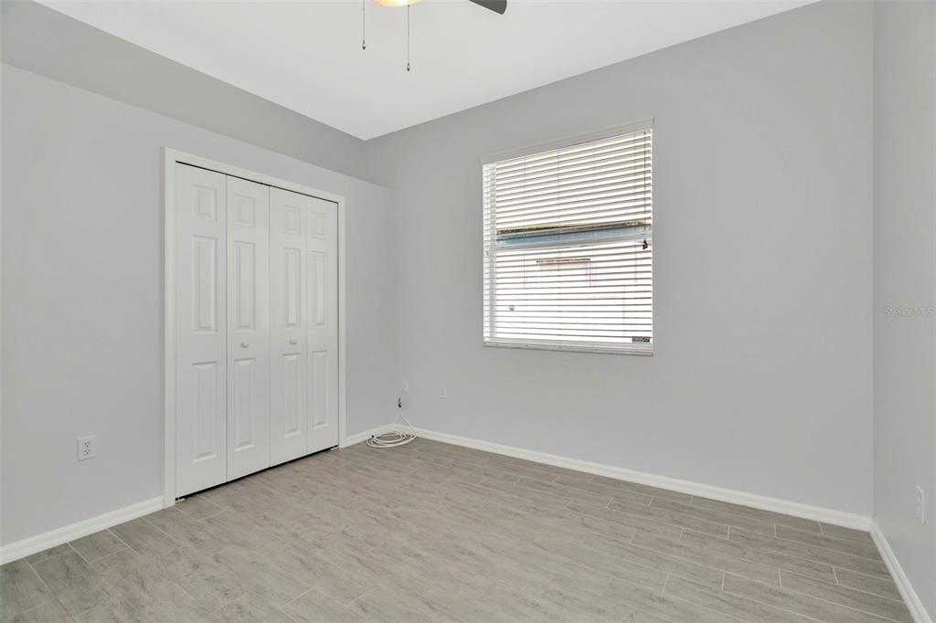 8918 Linebrook Drive Trinity, FL 34655 - Photo 40 of 50 an empty room with wooden floor and windows
